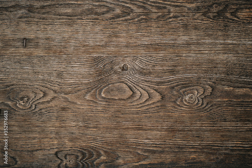 Light brown wood texture with jagged circles and curved lines. Background with natural wood pattern for text, image or product. Beautiful drawing on the surface of the board