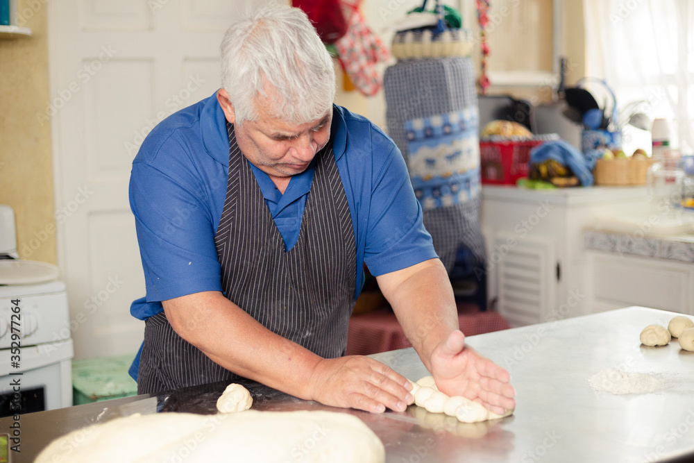 Hispanic adult man preparing bread dough - male hands preparing dough - baked wheat bread - older man making artisan bread Hispanic adult man preparing bread dough - male hands preparing dough - baked wheat bread - older man making artisan bread
