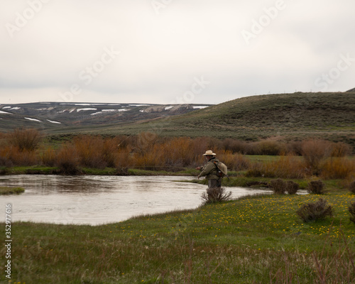 A single man fly fishing in the high country of Wyoming.