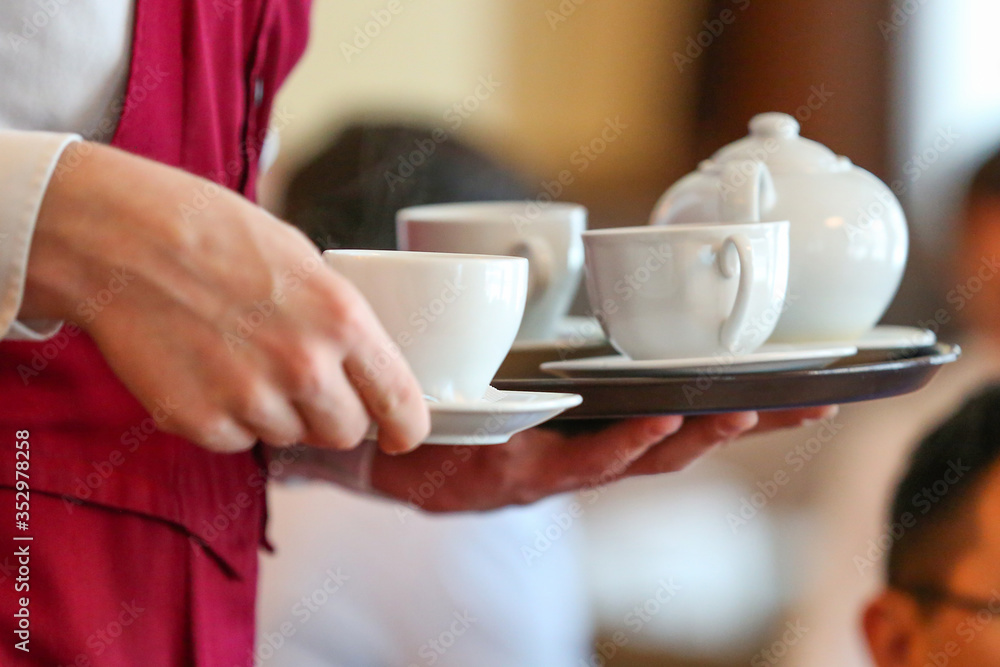 the waiter in the cafe brought customers tea the waiter in the cafe brought customers tea