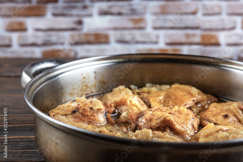Chicken thighs fried in a pan, close-up, shallow depth of field, selective focus. Homemade food concept.
