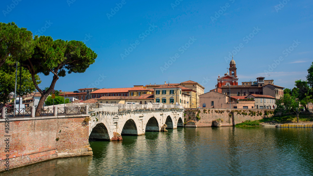 Old bridge over the river in the city of Rimini. Old Italy architecture