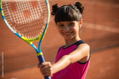 portrait of a smiling and happy young tennis player