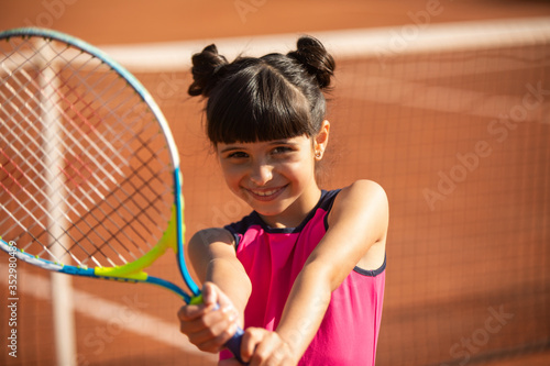 portrait of a smiling and happy young tennis player