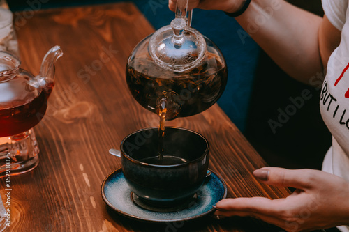 pouring tea into cup