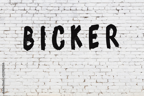 Bild auf Leinwand Word bicker painted on white brick wall