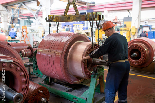 Ussuriysky Locomotive Repair Plant. Workers stand behind the machines at the factory and work. photo