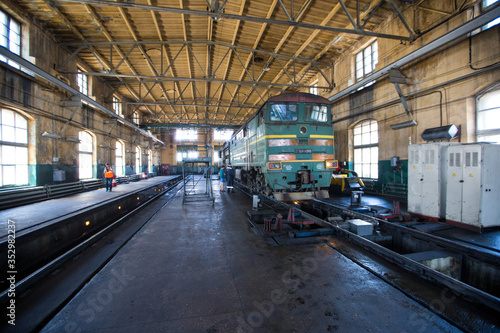 Ussuriysky Locomotive Repair Plant. An old locomotive car is being repaired in a railway depot