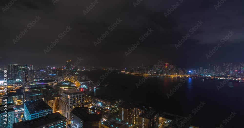 Hong Kong China, night cityscape time lapse from observation deck of tall hotel on mainland facing island. Includes 4 clips - the same view from 2 different days + panning versions of the 2 shots. Hong Kong China, night cityscape time lapse from observation deck of tall hotel on mainland facing island. Includes 4 clips - the same view from 2 different days + panning versions of the 2 shots.