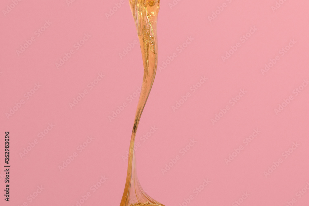 Obraz premium Sugar paste for hair removal on pink background. Product structure demonstration. Concept epilation. Flowing honey image for healthy life. Copy space