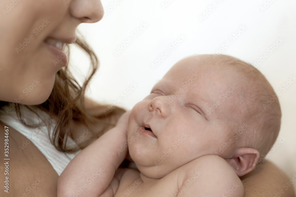 Portrait of a sleeping newborn baby with a mother close-up Portrait of a sleeping newborn baby with a mother close-up