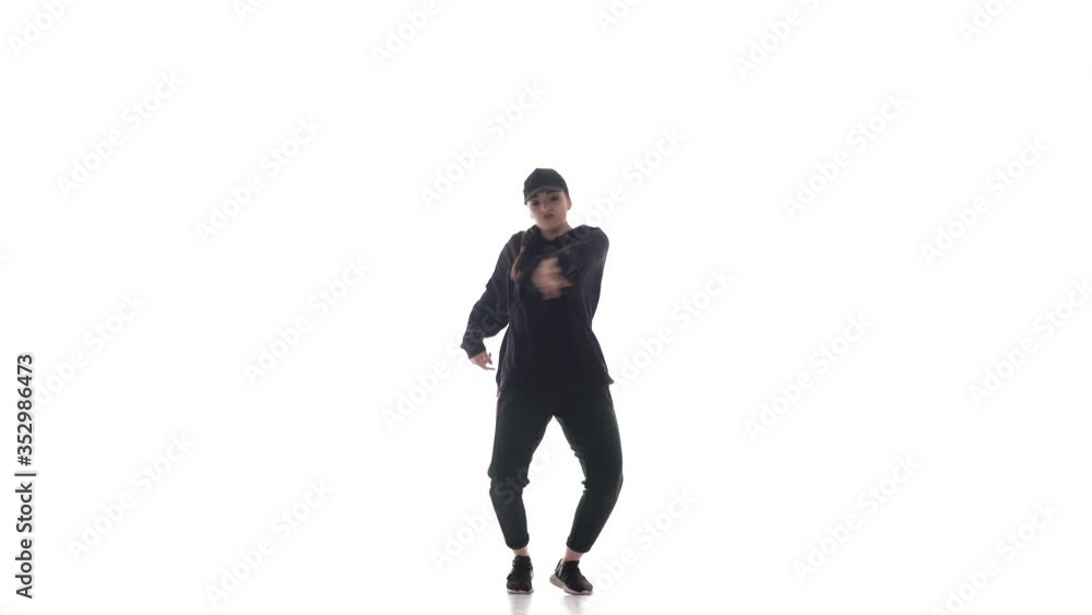 young beautiful girl dancer in tracksuit and baseball cap dancing hiphop, contemporary, modern street dance, isolated young beautiful girl dancer in tracksuit and baseball cap dancing hiphop, contemporary, modern street dance, isolated