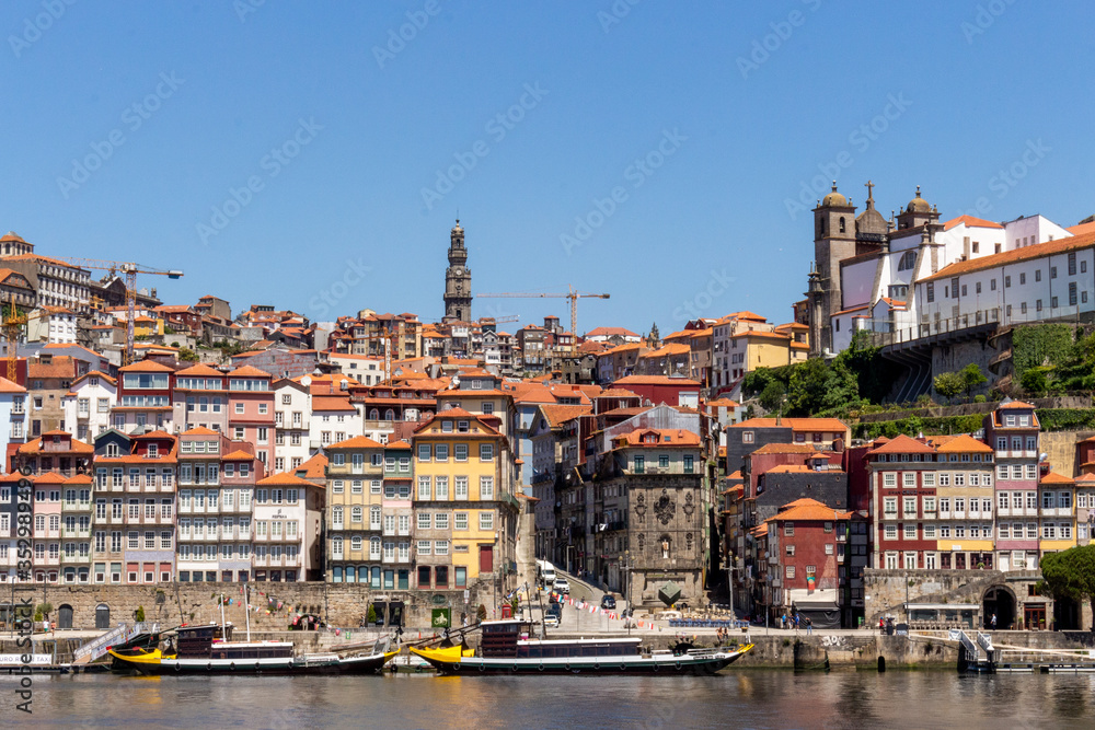 Colorful houses of Porto Ribeira, traditional facades, old multi-colored houses with red roof tiles on the embankment in the city of Porto, Portugal. Unesco World Heritage.
