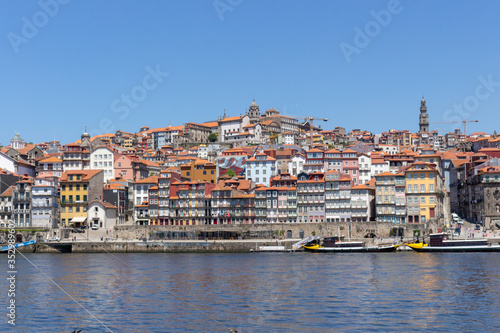 Colorful houses of Porto Ribeira, traditional facades, old multi-colored houses with red roof tiles on the embankment in the city of Porto, Portugal. Unesco World Heritage.