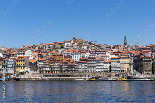 Colorful houses of Porto Ribeira, traditional facades, old multi-colored houses with red roof tiles on the embankment in the city of Porto, Portugal. Unesco World Heritage.