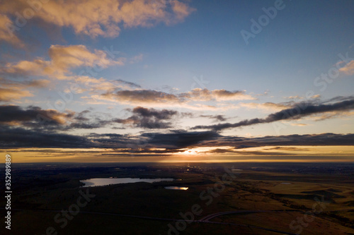 sunrise with clouds over distant lake