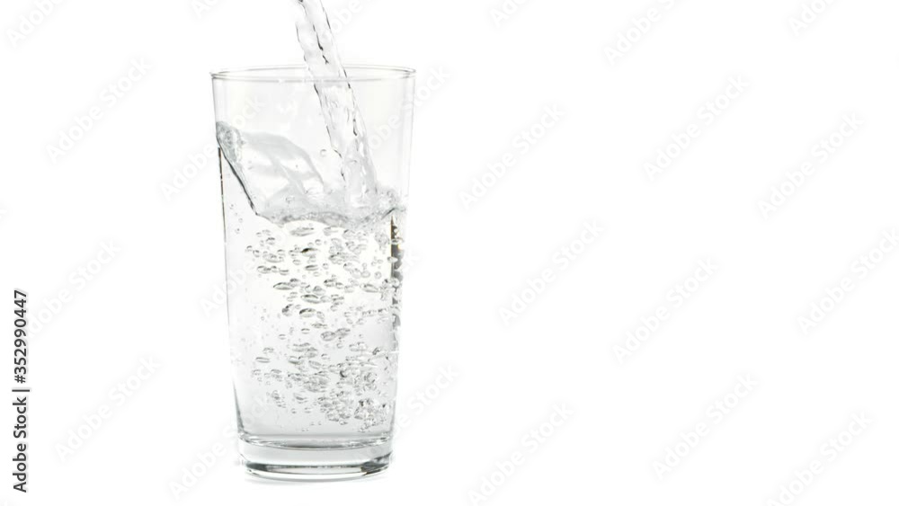 Super Slow Motion Shot of Pouring Fresh Water into Glass at 1000fps, Isolated on White Background. Super Slow Motion Shot of Pouring Fresh Water into Glass at 1000fps, Isolated on White Background.