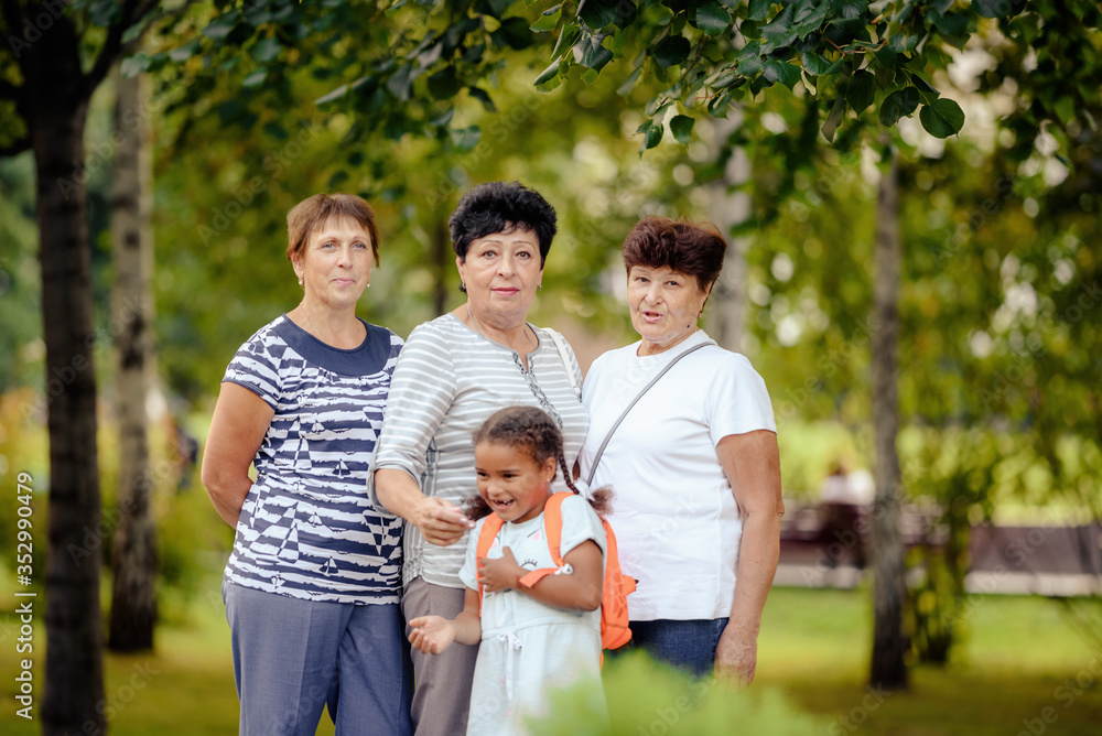 Mature Female Friends Socializing In Backyard Together. Mature Female Friends Socializing In Backyard Together.