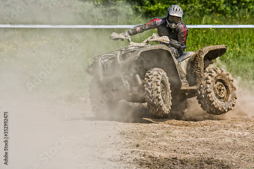 ATV Quad rides fast on big dirt and makes splashes of dirty water, quad racing, ATV 4x4. ATV rider.