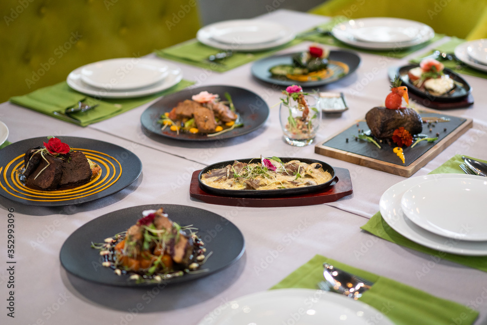 many different dishes arranged on the table view of the chef in a restaurant many different dishes arranged on the table view of the chef in a restaurant