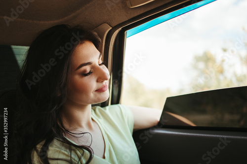 Young delighted woman traveling by car. Road car trip lifestyle, destination and travel concept © Vadym