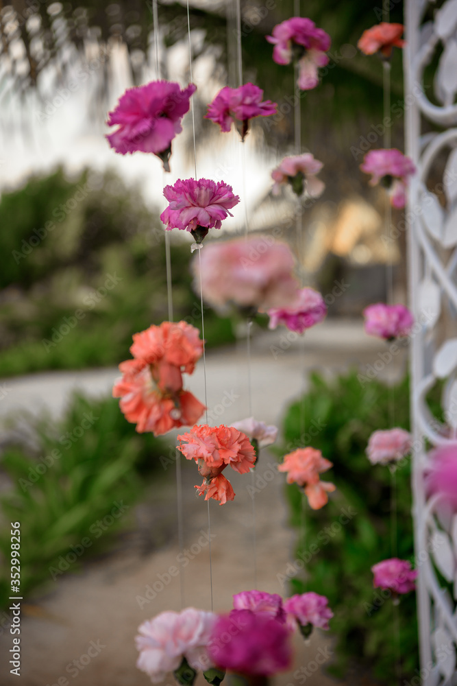 Scenery of flowers of white and pink roses on a wedding arch.