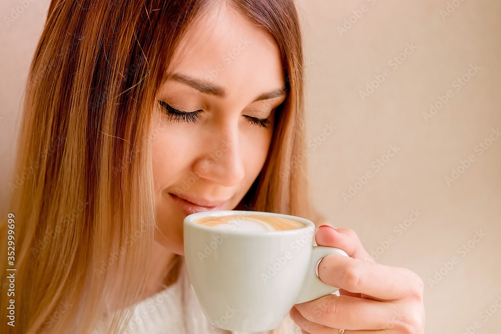 beautiful sexy blonde holds a cup of coffee. girl enjoys a delicious drink, morning ritual. beautiful sexy blonde holds a cup of coffee. girl enjoys a delicious drink, morning ritual.