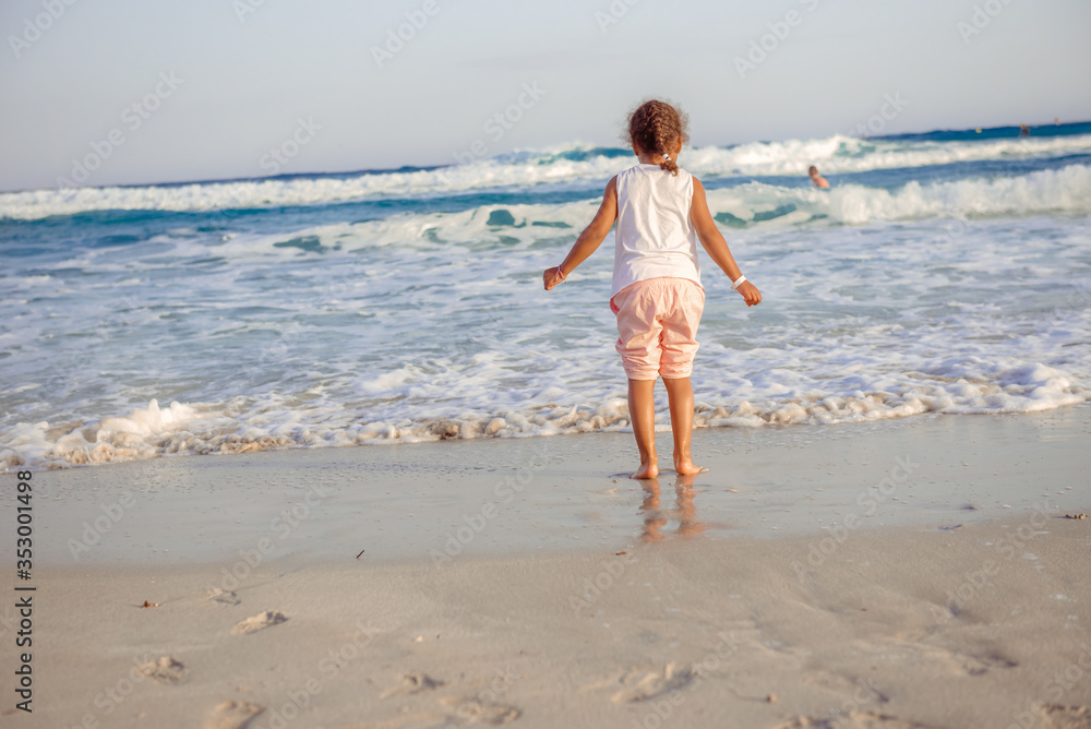 happy little girl have fun and joy time at beautiful beach happy little girl have fun and joy time at beautiful beach