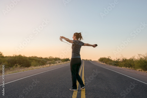 free woman with covers face in hand walking towards freedom