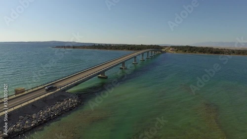 Wallpaper Mural Aerial shot of cars on bridge over ocean against blue sky, drone flying forward over sea on sunny day - Razanac, Croatia Torontodigital.ca
