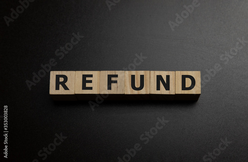 Letter block in word refund on wood background