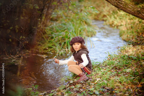 Fototapeta Naklejka Na Ścianę i Meble -  Happy Little Girl playing in the river.