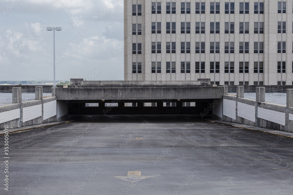 Empty parking deck in a generic downtown setting with office building