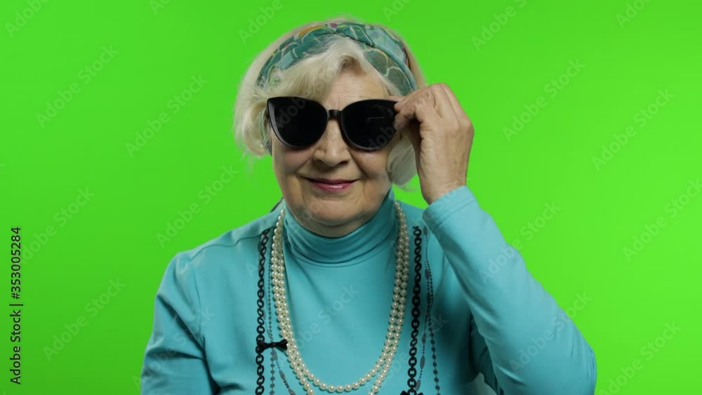 Elderly stylish grandmother. Caucasian woman posing on chroma key background Elderly stylish grandmother. Caucasian woman posing on chroma key background