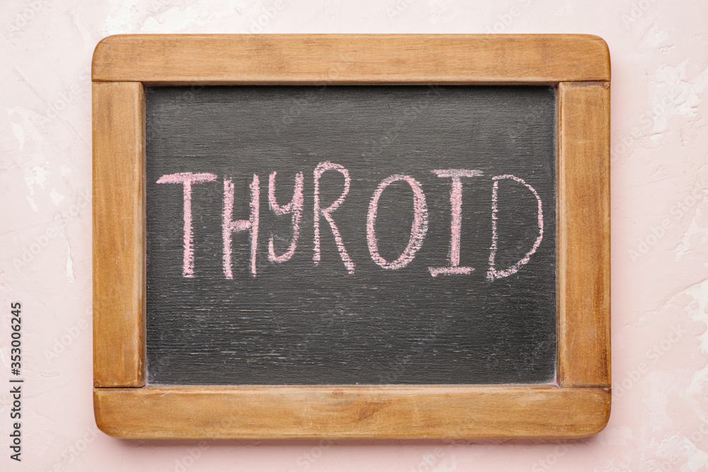 Board with text THYROID on color background Board with text THYROID on color background