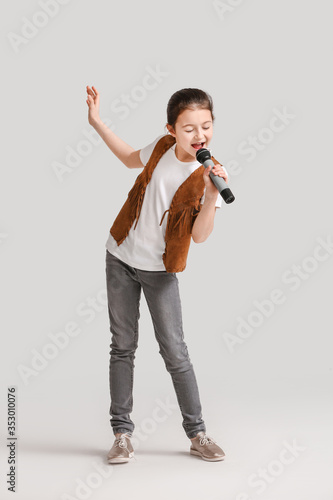 Cute little girl singing ag...