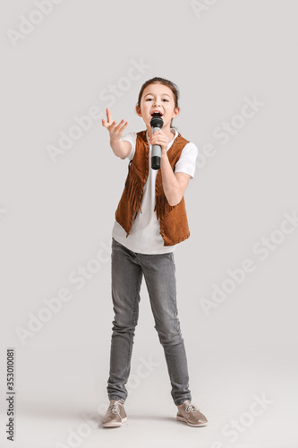 Cute little girl singing ag...