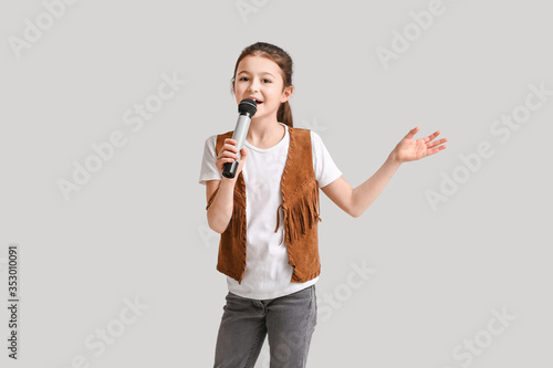Cute little girl singing ag...