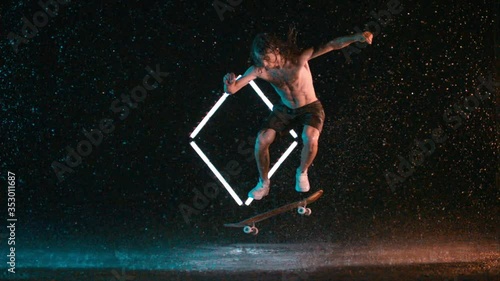 Advanced skateboard ollie double kickflip trick, wet rain studio, caucasian man photo