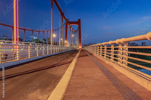 Perspective view of night road of large suspension bridge