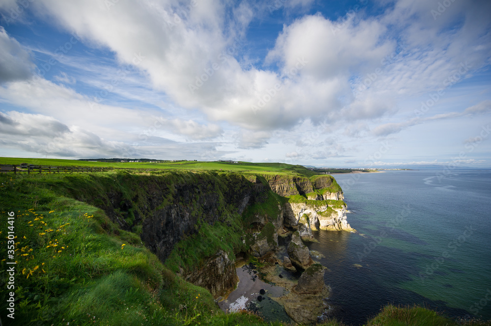 Costal view near Portrush, Northern Ireland. Beautiful green landscape with cliffs and sandy beaches. Costal view near Portrush, Northern Ireland. Beautiful green landscape with cliffs and sandy beaches.