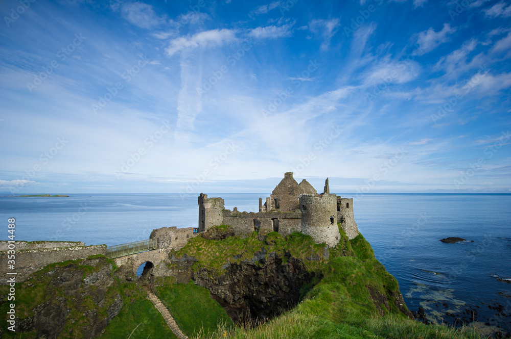 Ruins of Dunluce castle in County Antrim, Northern Ireland. The fort was built along the coastline cliffs.