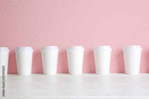 Many blank cups on white table