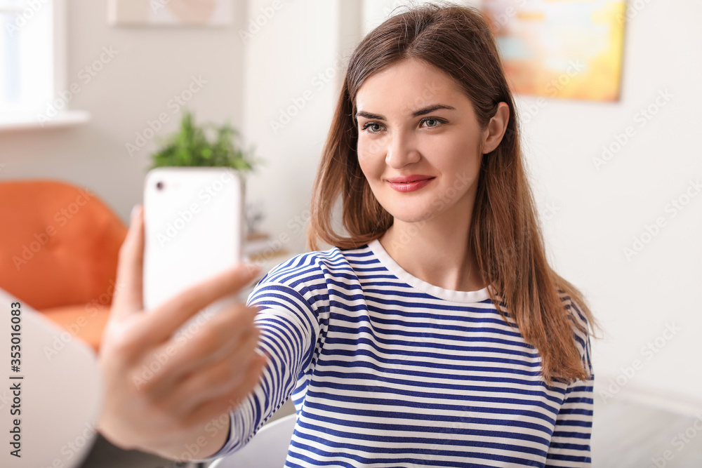 Beautiful young woman taking selfie at home Beautiful young woman taking selfie at home