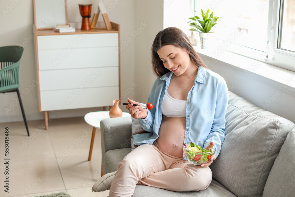 Beautiful pregnant woman eating salad at home Beautiful pregnant woman eating salad at home