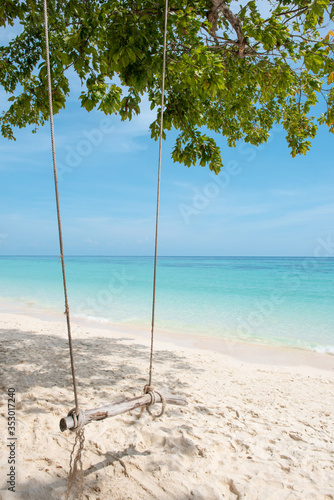 Wooden swing hang under tree at Koh Phak Bia Island, Krabi, Thailand. Travel destination and nature environment concept , summer holiday background. © Thanumporn