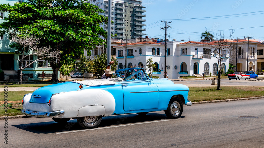 Vintage classic American car in a colorful street of Havana, Cuba.
