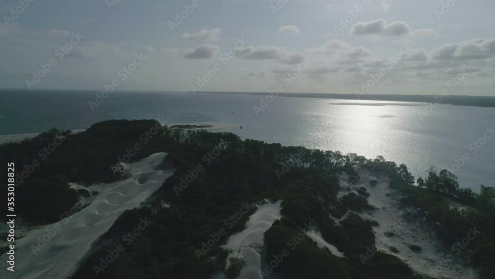 Sea with sun reflection, vegetation and dunes of northeast Brazil, a hidden beach Sea with sun reflection, vegetation and dunes of northeast Brazil, a hidden beach