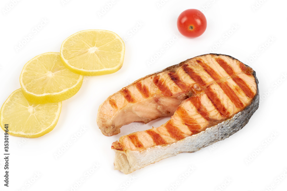 Grilled salmon steak wih lemon and tomatoes isolated on white background Grilled salmon steak wih lemon and tomatoes isolated on white background
