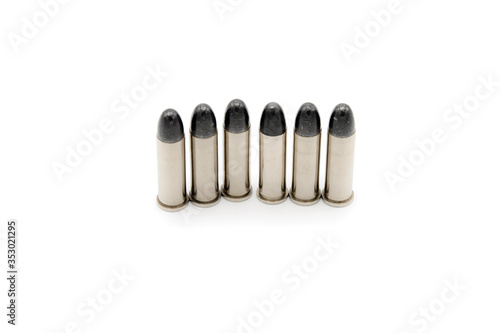 Photo 38mm bullet 6 silver bullets for a short gun on white background